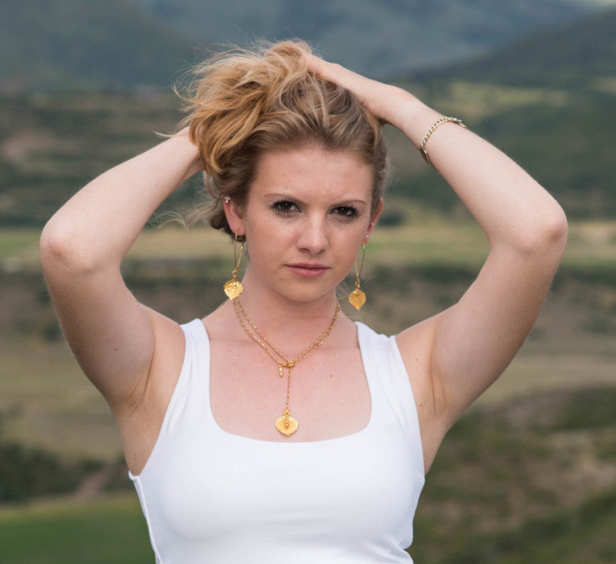 Classic Gold chain creates this dramatic Y style long necklace with a small Gold leaf