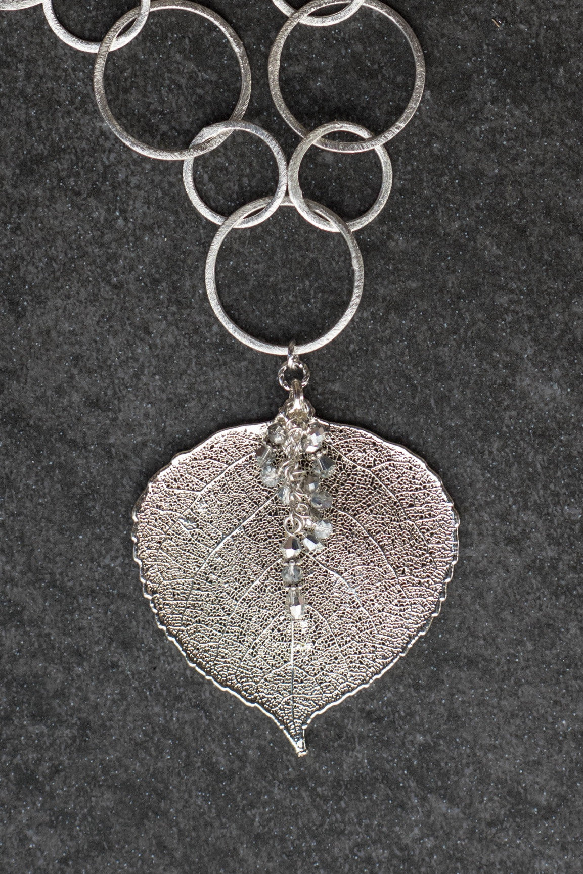 Signature Silver chain combined with a large Silver leaf and crystal dangles creates this striking necklace