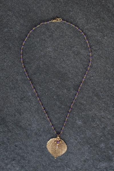 Gems in gold chain: Amethyst gems accent this classic princess style necklace with a gold leaf and Amethyst dangle