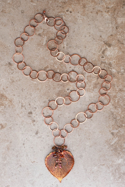 Signature Copper chain combined with a large Copper leaf and crystal dangles creates this striking necklace