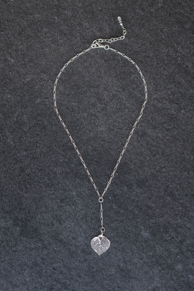 Classic silver chain creates this dramatic Y style necklace with a small Silver leaf