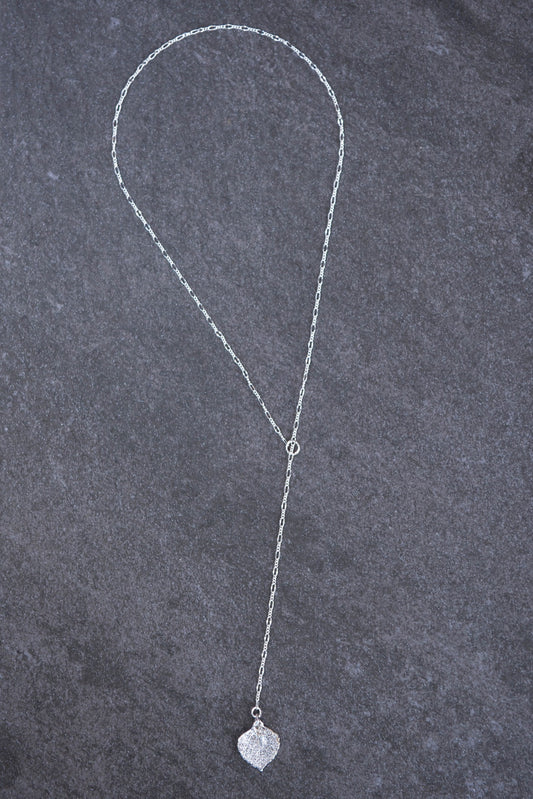 Classic Silver chain creates this modern lariat necklace with a small Silver leaf and crystal dangle