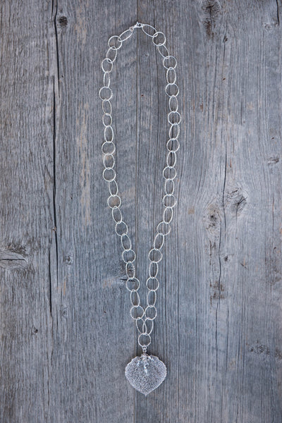 Classic silver faceted chain creates a modern long necklace with a Silver leaf and crystal dangles