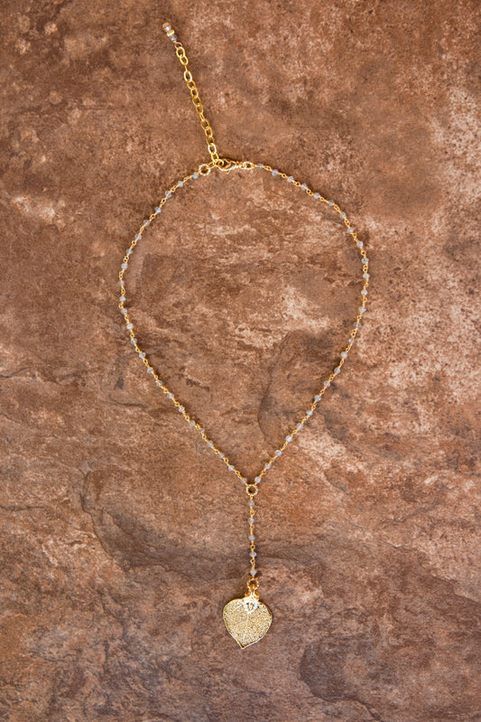 Gems in gold chain: labradorite gems accent the dramatic Y style necklace with a small gold leaf