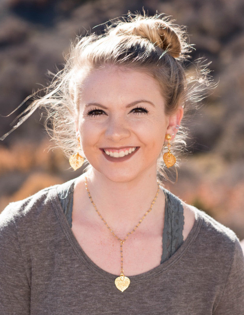 Gems in gold chain: labradorite gems accent the dramatic Y style necklace with a small gold leaf