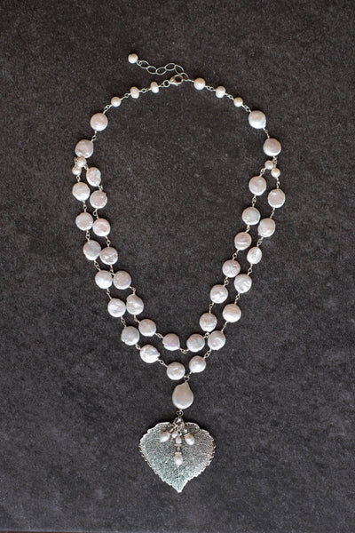 Wire twisted silver wire combine 2 strands of white freshwater coin pearls with a silver Aspen leaf & pearl dangle.