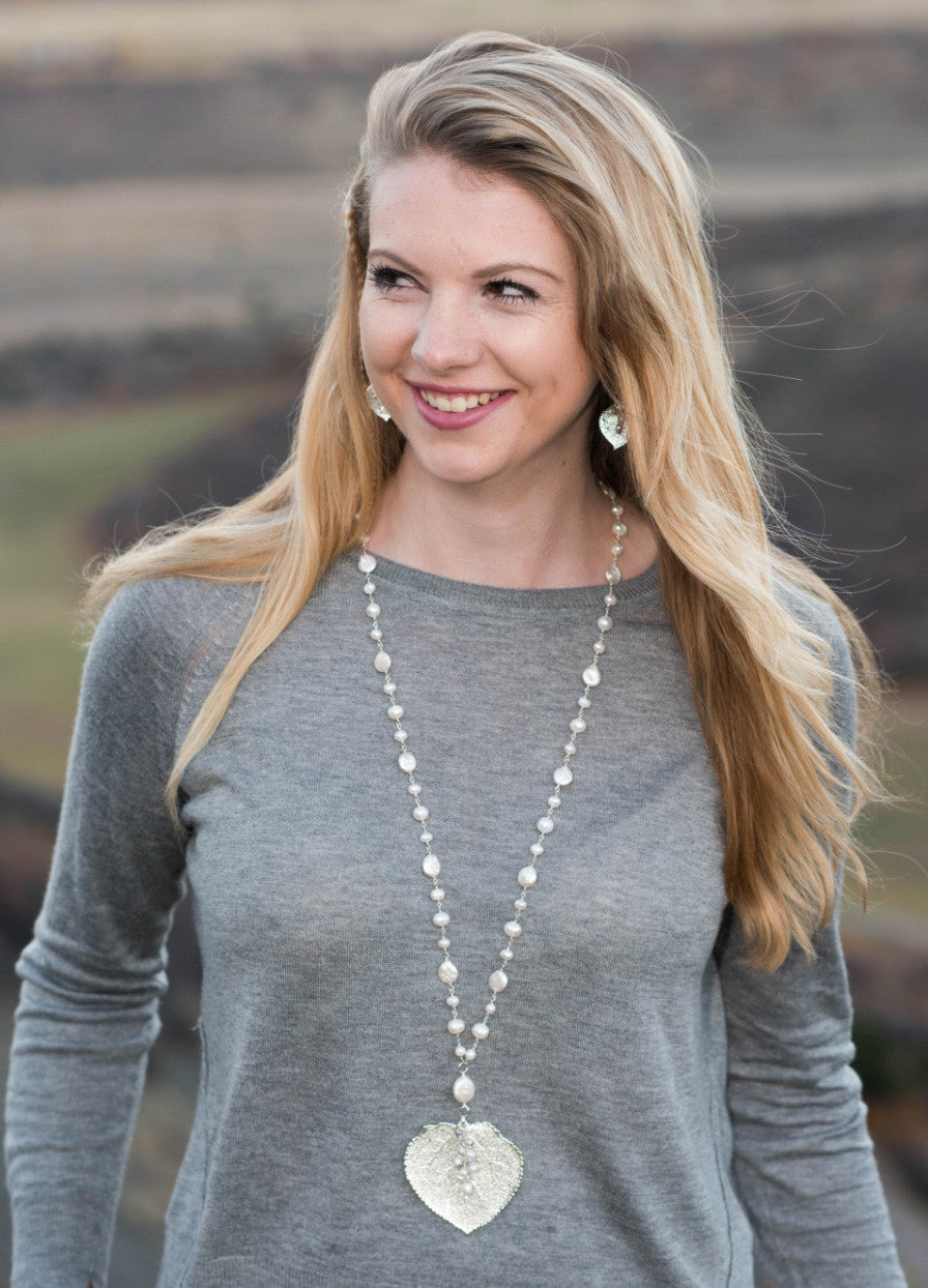 Wire twisted silver combine long strands of white freshwater & coin pearls finished with a Silver Aspen leaf & pearl dangle.