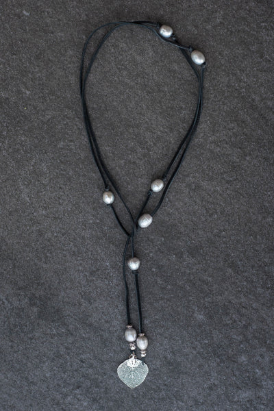 Lariat: Eight pearls highlight this versatile necklace, Silver freshwater pearls, silver Aspen leaf, black deerskin leather.
