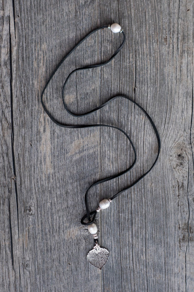Three White pearls, silver leaf, black leather creates this original and trendy necklace