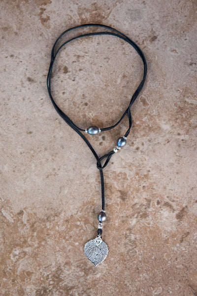 Three peacock pearls, silver leaf, black leather creates this original and trendy necklace