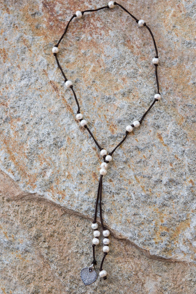 White fresh water pearls accent this stunning silver Aspen leaf, brown leather necklace.